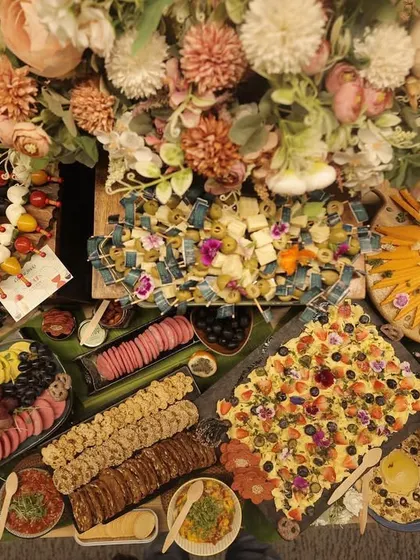 An overhead shot of a bountiful grazing table, showcasing the rich colors and textures of the spread. You can see the variety of cheeses, charcuterie, and fresh produce I use to make each table a unique work of art.