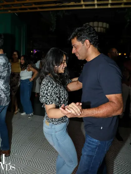 A happy couple dancing together, their smiles reflecting the joy of the moment.