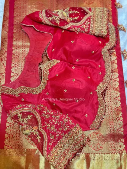 The front of the red bridal blouse, with delicate floral embroidery.