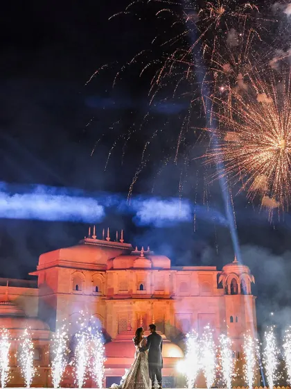A breathtaking reception moment as fireworks light up the sky behind the couple at Fairmont Jaipur. We work with magnificent heritage venues to create a perfect blend of history and modern celebration.