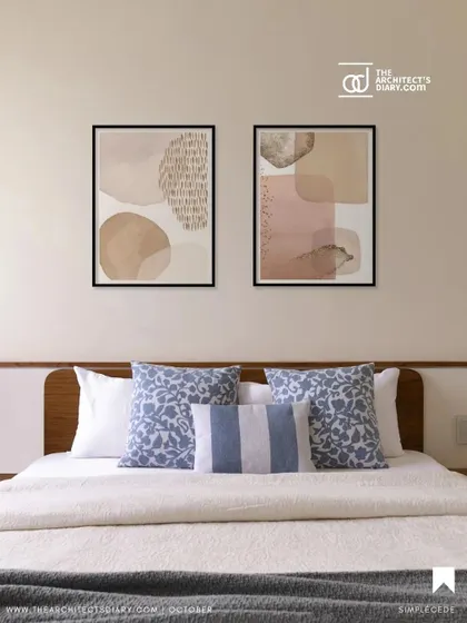 This bedroom from 'A Walk in the Clouds' features a simple, clean design with a wooden headboard, crisp white bedding, and pops of blue in the cushions, creating a calm and refreshing space.