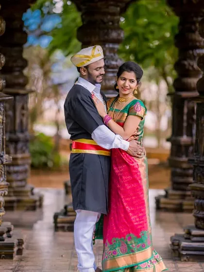 A romantic embrace amidst a forest of ancient pillars. The couple's traditional outfits look stunning in this timeless, architectural location.