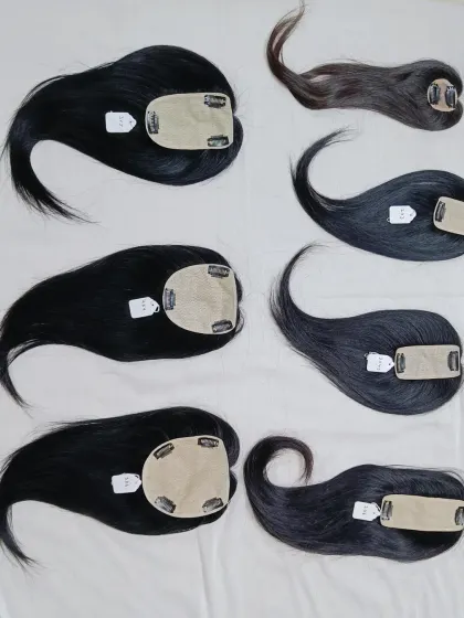 A collection of my human hair toppers, showcasing different sizes and the natural parting that makes them look so realistic.