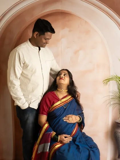 A beautiful moment between a couple during their traditional saree maternity shoot. The mutual gaze shows their shared journey and anticipation.