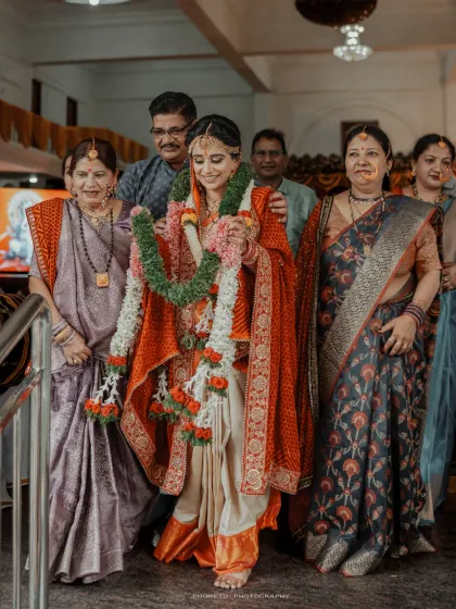 The bride, surrounded by her loving family, makes her way to the ceremony, a moment filled with emotion and support.