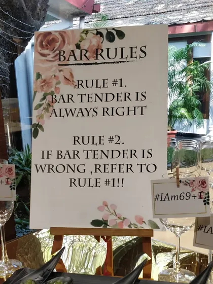 We love to have fun with our clients. This custom sign for a 70th birthday party lays down the "Bar Rules," including "Rule #1: Bartender is always right," adding a playful touch to the celebration.