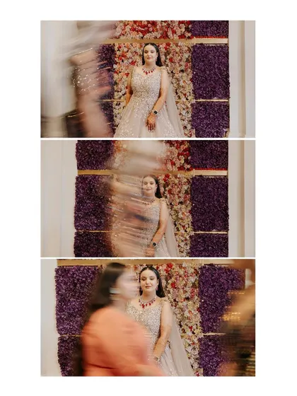 An artistic shot using motion blur as people walk past the bride, creating a dynamic effect that makes her the calm, central focus of the image.