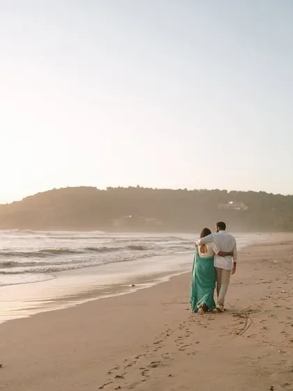 Walking into the future, together. A serene beach at sunset provides a timeless backdrop for love stories, showing our expertise in destination and golden hour couple portraits.