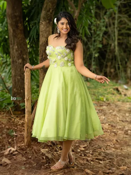 A full-length shot that shows the flow of the dress in a natural setting. This is a great example of an outdoor fashion portrait that feels both elegant and down-to-earth.