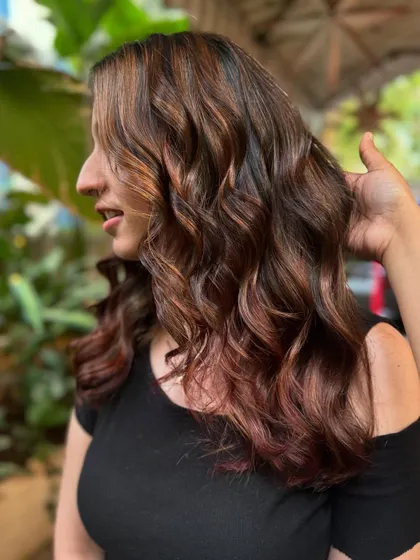 A happy client showing off her new balayage. The mix of brown tones with a hint of red gives a unique and beautiful result. (No filter)