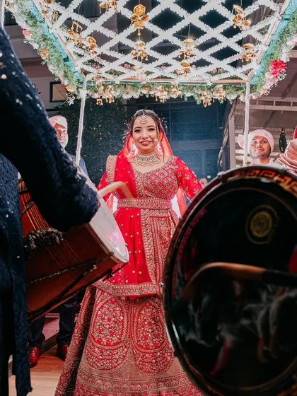 The bride's joyful entry, dancing to the beat of the dhols. I love creating high-energy bridal entries that reflect the bride's personality.