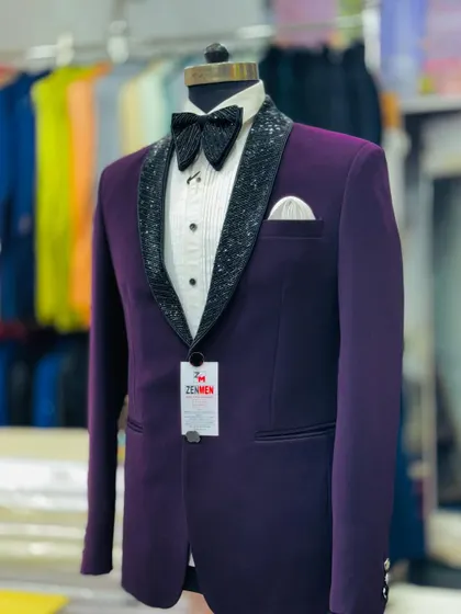 Another view of the purple tuxedo with the black sequined lapel, showing the sharp tailoring and modern fit.