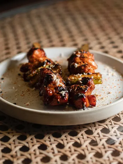 Tandoori chicken skewers plated with a modern twist. The image highlights the fusion concept of the dish.