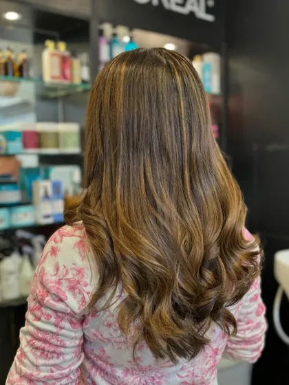 This is a classic and beautiful example of caramel highlights on a brown base. It adds brightness and dimension for a timeless, sun-kissed look.