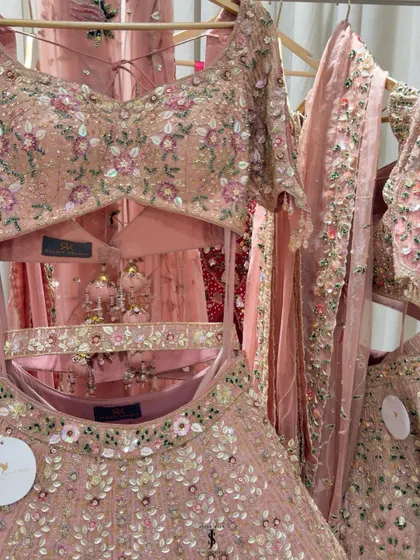 A rack of beautiful pastel lehengas from Rachit Khanna's collection. The intricate floral embroidery and modern silhouettes are perfect for a contemporary bride.