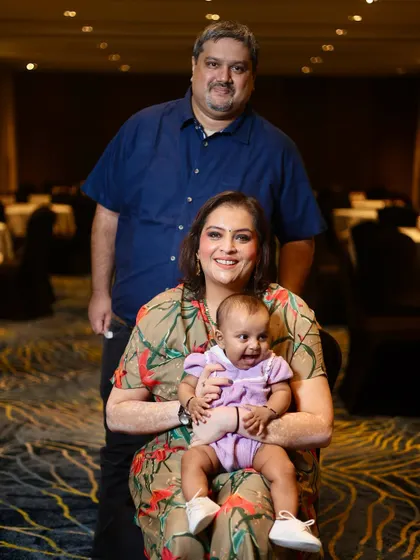 A joyful family portrait with the baby making a happy expression. Capturing these spontaneous moments is what makes family photography so special.