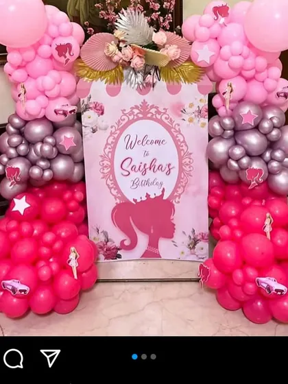 A glamorous welcome sign for Saisha's Barbie-themed birthday, framed by columns of pink and silver balloons.