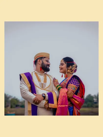 A sweet and simple portrait of the couple looking at each other, framed against a soft, neutral background.