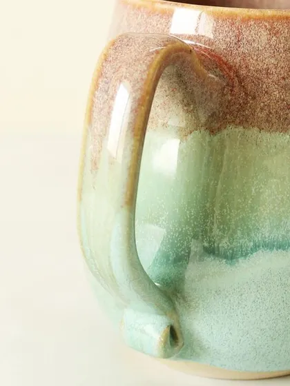 A detailed look at the handle and the smooth, glossy finish of the Pist-a-chio mug. I pay close attention to the ergonomics to ensure every sip is a comfortable experience.