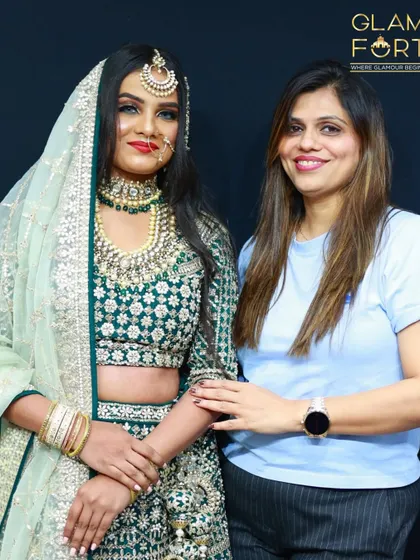 Here I am with a model showcasing a stunning Valima look. The mint green and silver outfit is complemented by a soft, shimmery eye and a bold lip, creating a look of pure elegance.