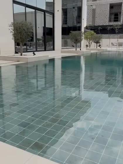 The reflection of the sky and our planted trees in the still pool water adds a sense of tranquility to this modern outdoor space.