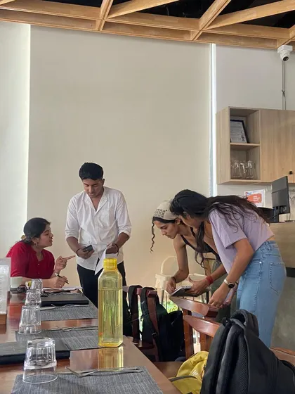 Sometimes we take our classes off site. Here, students are engaged in an interactive session at a local cafe, applying their language skills in a new environment.