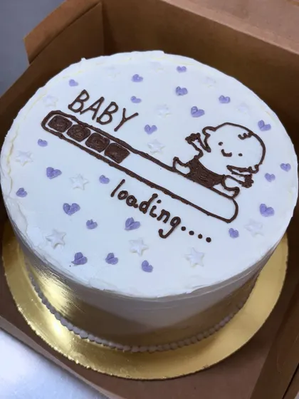 A cute and simple "Baby loading..." cake. This minimalist design is a fun and modern way to announce a pregnancy or celebrate at a casual baby shower.