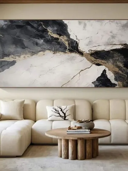 This large-scale abstract painting in black, white, and gold makes a dramatic statement. It shows how abstract art can bring a sense of luxury and dynamic energy to a contemporary living space.