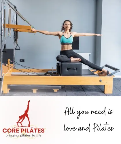 All you need is love and Pilates. This client demonstrates a beautiful side bend on the Reformer, showcasing both strength and flexibility.
