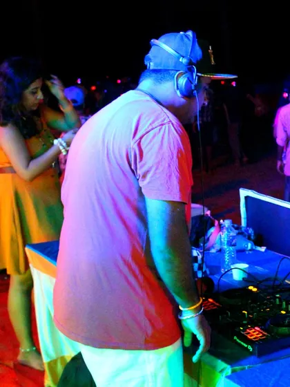 The DJ at work, setting the vibe for a fantastic beach party. I work with professional DJs to ensure the music is always on point.