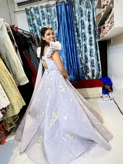 The back of the lavender gown, showing its full, flowing skirt. It’s an outfit that looks beautiful from every angle.