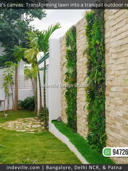 A view of the backyard showing the stone wall with vertical garden panels, the lawn, and a stone pathway. This demonstrates how I combine different elements to create a cohesive landscape.