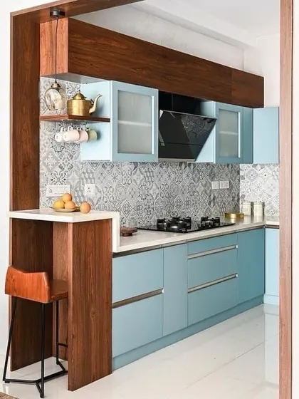 A beautiful parallel kitchen with a small breakfast nook and bar stool. The patterned tile backsplash and powder-blue cabinets create a charming and unique look.