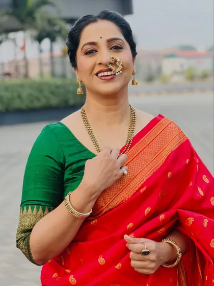 A close-up showcasing the traditional Maharashtrian jewelry, including the iconic nath. The makeup focuses on defined eyes and a warm lip color, perfecting this classic look.