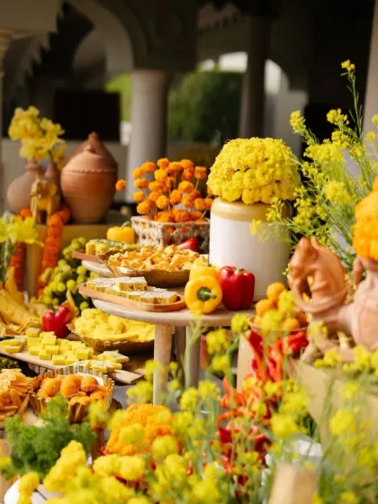 A vibrant food display for the Haldi, where the colors of the fresh produce and snacks are integrated into the overall yellow and orange decor scheme.