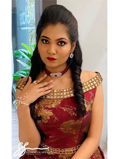 A close-up of the modern Sangeet makeup, showing the sharp eye definition and rich lip color that pairs beautifully with the off-shoulder gown.