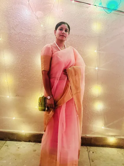 Another photo from the Durga Puja celebrations, with festive lights in the background. This captures the joyous and spiritual atmosphere of Indian festivals.
