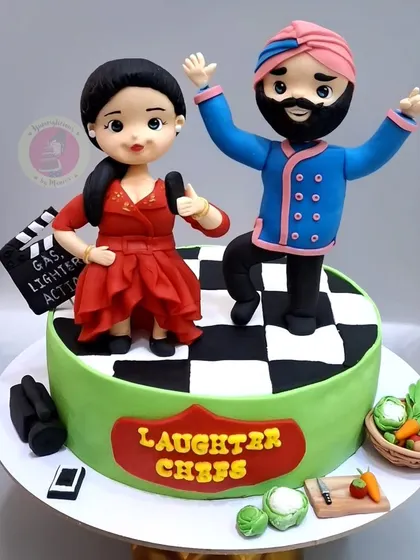 The final "Laughter Chefs" cake, featuring the handcrafted figurines of Bharti Singh and Chef Harpal on a checkerboard stage.