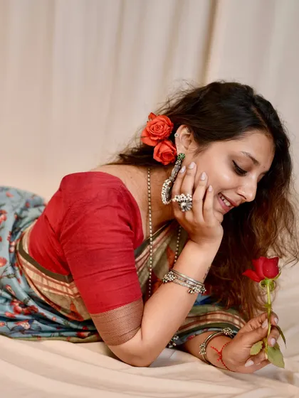 A romantic, dreamy shot from my personal saree photoshoot, using a single rose as a simple, elegant prop.