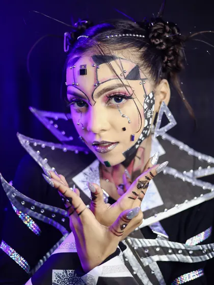 A futuristic, geometric makeup look with sharp lines and metallic accents.
