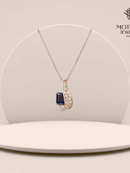 A graceful pendant featuring a deep blue sapphire in a swirling diamond setting. The elegant design and rich color make this a sophisticated piece for any jewellery lover.