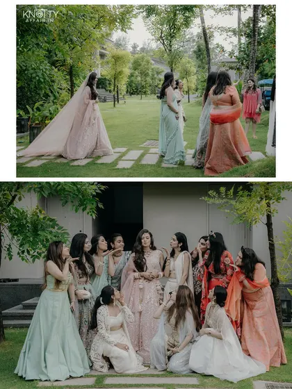 The bride with her squad of bridesmaids, posing for fun and elegant group photos in a beautiful garden setting.