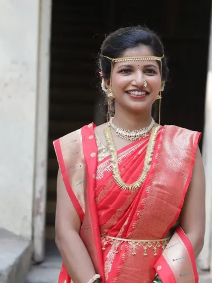 My happy bride Sanchita, looking radiant in a red saree for her wedding ceremony. Her natural smile says it all. The makeup is kept minimal to highlight her joy.