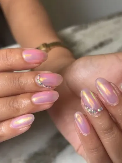 A close-up shot showing the beautiful color shift in this pink and gold iridescent chrome. The added rhinestones provide a perfect touch of sparkle.