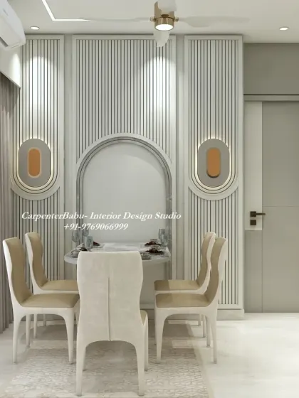 A compact dining nook with a round table and elegant chairs. The wall is adorned with fluted panels and modern sconces, creating a cozy and stylish corner.