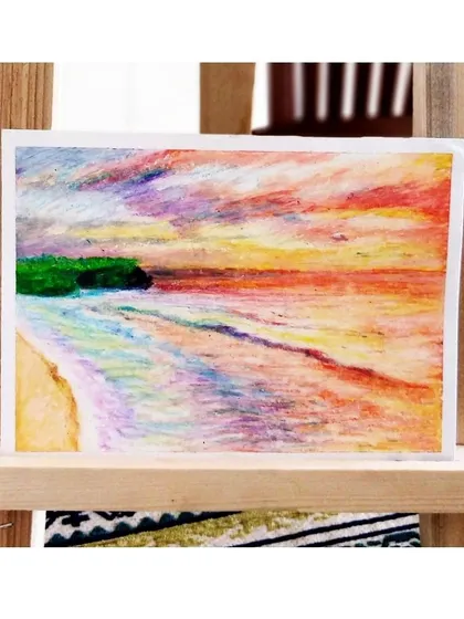 A soft, colorful beach scene rendered in oil pastels, demonstrating how this medium can be used to create gentle, blended effects.