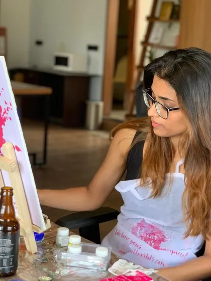A guest enjoying a quiet, focused moment at our koi fish painting workshop. It's a great way to practice mindfulness and creativity.