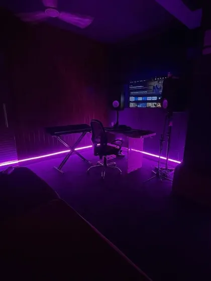 We believe the right atmosphere inspires great music. Our studio features adjustable mood lighting, like this vibrant purple glow, to help you create the perfect vibe for your creative session, whether you're recording, writing, or just jamming.