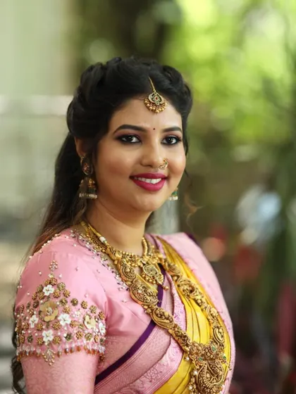 A portrait of my lovely bride. I designed this pink blouse with floral bunch embroidery on the sleeves to complement her yellow and pink silk saree.