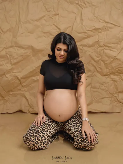 A powerful kneeling pose that exudes confidence. This high-fashion look is for the unapologetic mother who embraces her journey with strength and style.